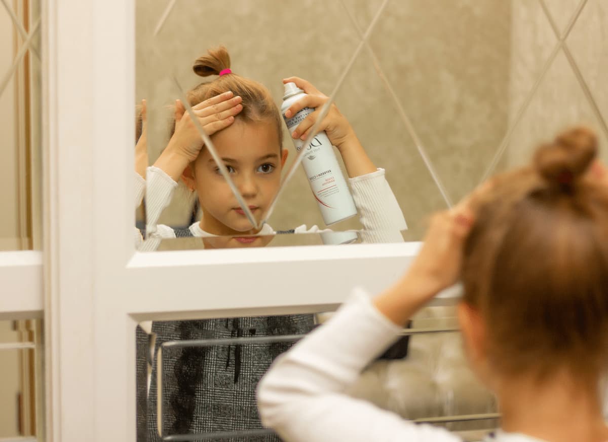 girl doing her hair with hairspray hair care 2024 10 15 03 31 00 utc 1